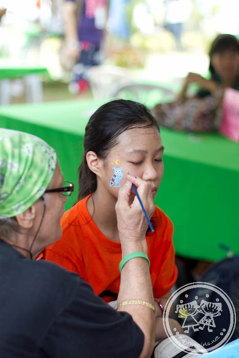 Girl having her face painted